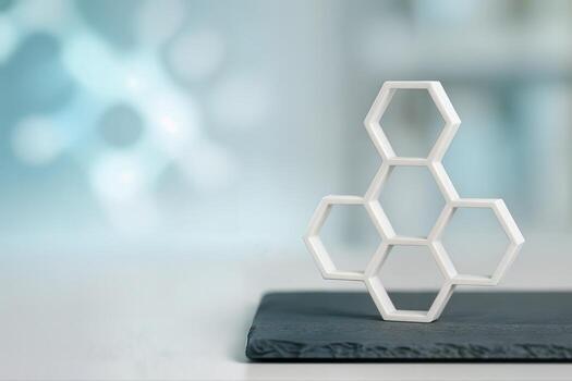 A Molecular Hexagon Sculpture Displayed Indoors on a Smooth Surface with a Blurred Background Showcasing an Abstract Design With Shallow Depth Of Field photo