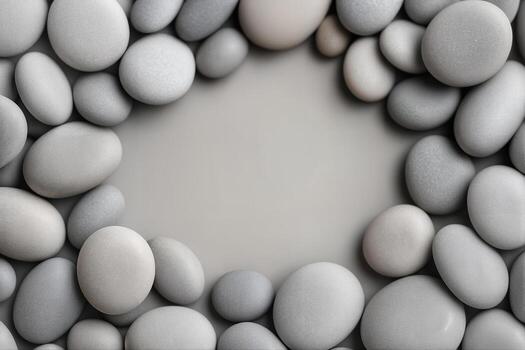 A collection of smooth, rounded pebbles arranged in a circular pattern on a flat surface, showcasing natural textures and muted colors photo
