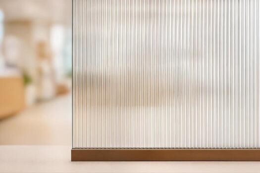Glass Partition Indoors Featuring Vertical Stripes With A Shimmering Finish In A Modern Interior Setting With Shallow Depth Of Field photo