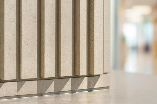 Stone Column Featuring Elegant Shadow Patterns in a Modern Indoor Setting with Soft Natural Light Creating an Artistic Contrast With Shallow Depth Of Field photo