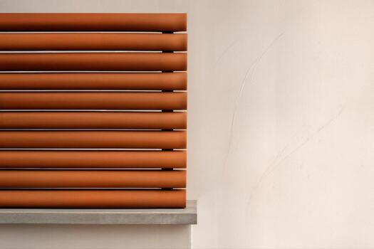 Terracotta Baguette Screen Displayed Indoors Against a Neutral Wall Providing a Modern Architectural Element with a Minimalist Aesthetic photo
