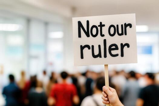 Protest Near A Government Building Featuring A Sign With 'Not Our Ruler' Amidst A Crowd Of Demonstrators With Shallow Depth Of Field photo