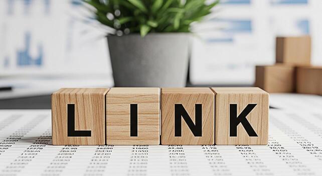 Wooden blocks spelling LINK sitting on a financial report in a bright office symbolizing connection relevance and the importance of data analysis in business strategy and decisionmaking for success photo
