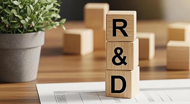 Conceptual image of wooden blocks spelling out RD on a wooden desk with financial reports symbolizing research and development in a business setting fostering innovation and strategic planning for fut photo