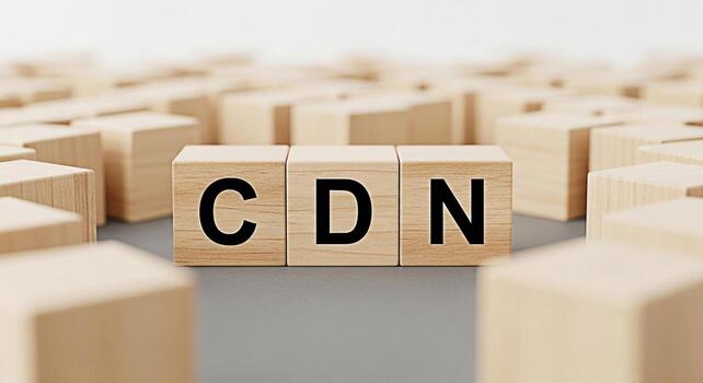 Wooden blocks displaying the acronym CDN representing Content Delivery Network arranged on a neutral surface among other blocks symbolizing efficient data distribution and optimized web performance in photo