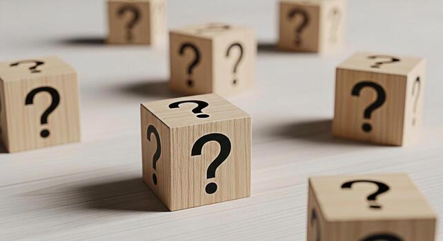Wooden blocks displaying question marks scattered on a bright surface representing uncertainty and the need for answers creating a sense of mystery and intellectual curiosity in a minimalist setting photo