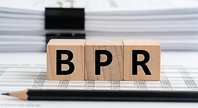 Wooden blocks spelling BPR resting on a financial spreadsheet with a pencil in a bright office environment symbolizing business process reengineering and strategic organizational change for improved e photo