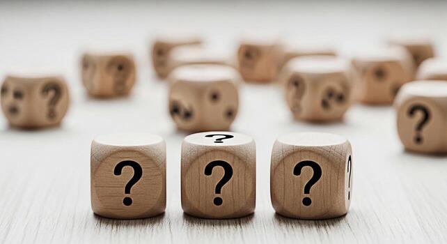 Wooden dice displaying question marks on a bright surface symbolizing uncertainty and the need for answers in decisionmaking creating a mood of contemplation and problemsolving photo