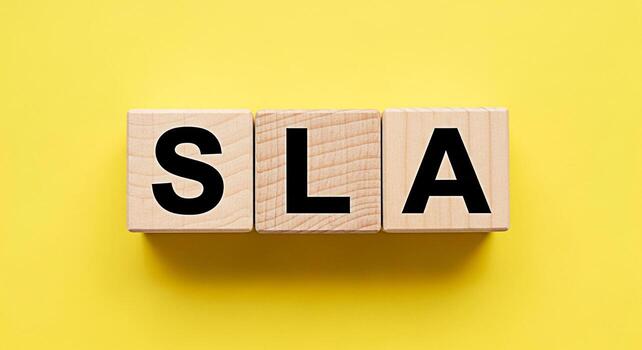 Wooden blocks displaying SLA on a bright yellow background representing Service Level Agreement crucial for business operations ensuring quality and reliability in service delivery promoting trust and photo