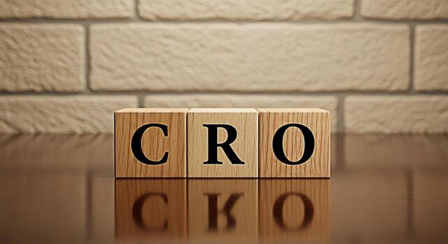 Wooden blocks displaying CRO on a reflective surface against a brick wall symbolizing Conversion Rate Optimization and a focus on improving online business performance and achieving success photo