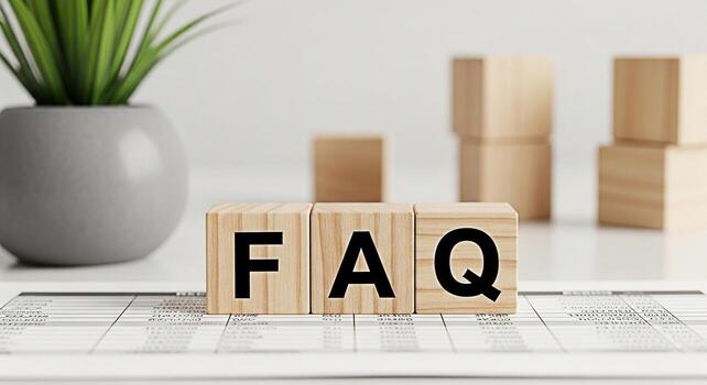 Wooden blocks spelling FAQ resting on a financial document in a bright modern office environment representing frequently asked questions and accessible information for business and customer support photo