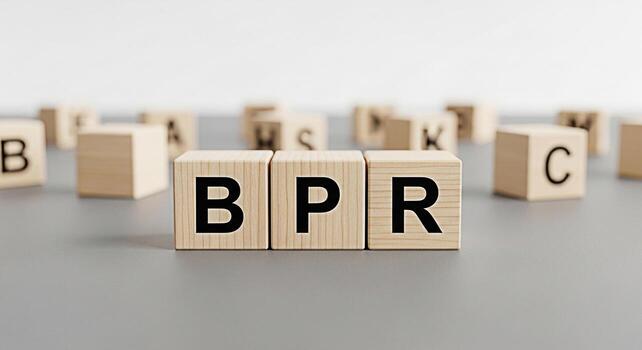Wooden blocks spelling out BPR on a gray surface suggesting Business Process Reengineering in a clean and minimalist setting conveying a message of efficiency and strategic improvement photo