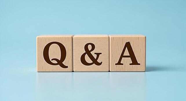 Wooden blocks displaying QA on a light blue surface representing questions and answers symbolizing knowledge learning and information exchange in a simple and clean studio setting photo