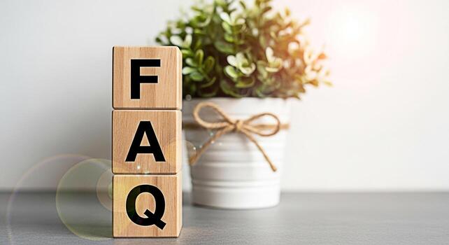 Wooden blocks displaying FAQ in a bright modern office environment symbolizing accessible information and customer support fostering a sense of transparency and helpfulness for website visitors and bu photo