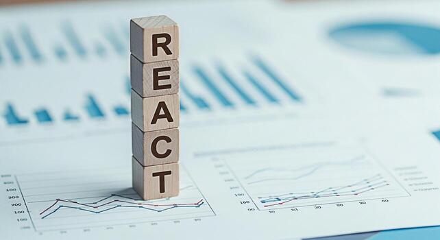 Wooden blocks spelling REACT standing on financial charts representing data analysis and strategic decisionmaking in a business environment conveying a message of proactive planning and informed actio photo