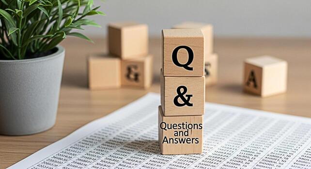 Wooden blocks displaying Questions and Answers on a desk with financial data symbolizing knowledge acquisition and problemsolving in a business environment fostering a sense of clarity and understandi photo