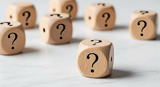 Wooden dice displaying question marks on a white marble surface representing uncertainty and the search for answers in a clean and minimalist setting evoking curiosity and problemsolving photo