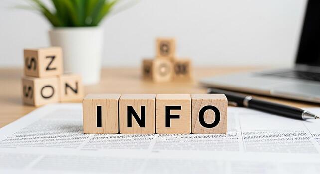 Wooden blocks spelling INFO on a desk with a laptop and pen conveying a message of information knowledge and data in a modern office environment promoting clarity and understanding photo