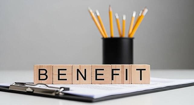 Wooden blocks spelling BENEFIT resting on a clipboard in a bright modern office setting symbolizing employee perks financial advantages and the positive aspects of a comprehensive compensation package photo
