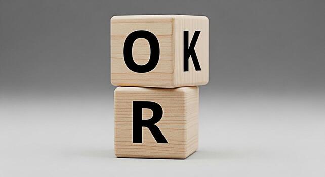Wooden block displaying the word OK against a neutral gray backdrop symbolizing agreement approval and positive affirmation in a simple minimalist style ideal for communication and confirmation concep photo