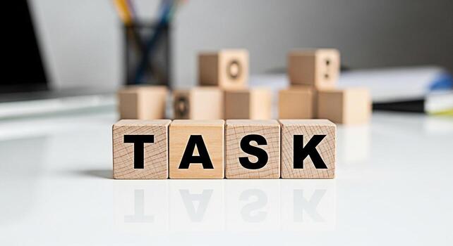 Wooden blocks spelling TASK on a white desk in a bright office symbolizing project management workload and the importance of focus and organization for achieving goals and boosting productivity photo
