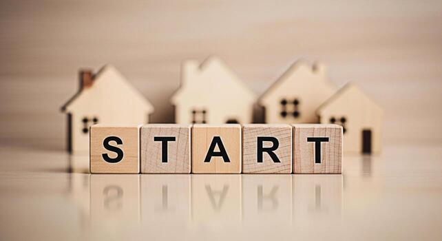 Wooden blocks spelling START in front of miniature house models on a reflective surface symbolizing new beginnings and the excitement of homeownership in a warm inviting setting photo