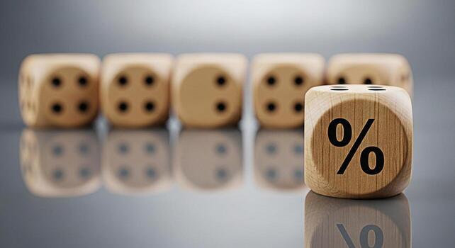 Wooden dice displaying a percentage symbol on a reflective surface representing interest rates and financial concepts in a business setting conveying a sense of risk and opportunity photo