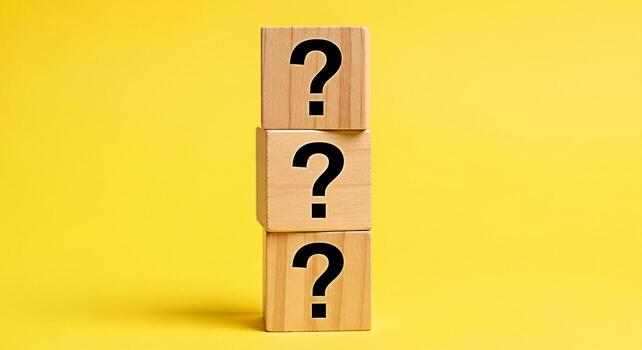 Stacked wooden blocks displaying question marks against a vibrant yellow backdrop symbolizing uncertainty inquiry and the search for answers in a bright and engaging visual concept photo