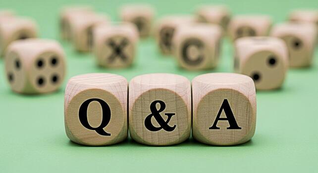Wooden dice spelling out Q A on a green surface representing questions and answers in a business or educational setting conveying a sense of clarity knowledge and problemsolving photo