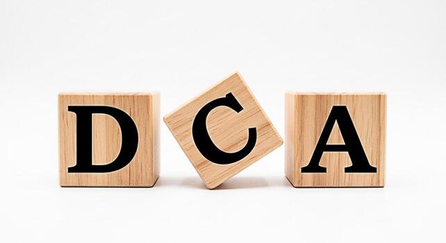 Wooden blocks displaying the letters D C and A on a white background symbolizing the concept of Dollar Cost Averaging a simple and effective investment strategy for longterm financial success photo