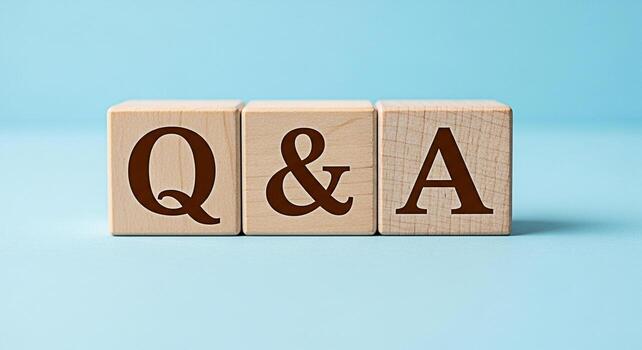 Wooden blocks displaying Q A on a light blue surface representing questions and answers knowledge sharing and information exchange in a simple and straightforward manner photo