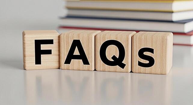 Wooden blocks displaying FAQs on a white table with blurred books in the background representing information assistance and customer support in a clean and modern setting conveying clarity and helpful photo