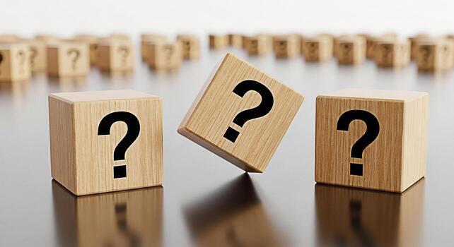 Wooden cubes displaying question marks on a reflective surface representing uncertainty and the search for answers in a conceptual and minimalist setting evoking curiosity and problemsolving photo