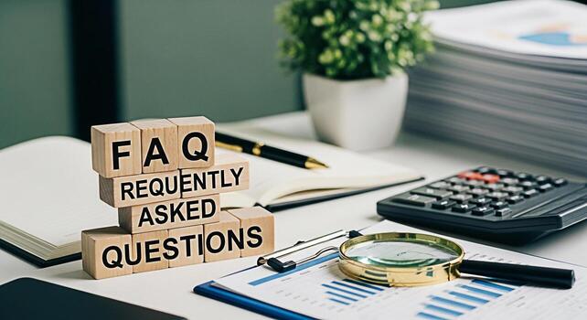 Wooden blocks spelling FAQ on a bright office desk with financial charts a calculator and a magnifying glass representing information access problemsolving and a helpful informative atmosphere photo