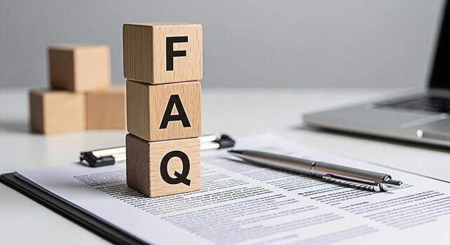 Wooden FAQ blocks stacked on a document with a pen in a bright office setting representing frequently asked questions and providing answers conveying clarity and information access photo