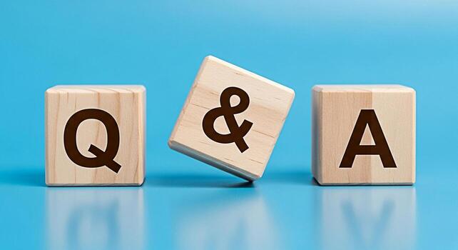 Wooden blocks displaying QA on a blue surface representing questions and answers in a learning environment creating a clear and concise visual for educational content and knowledge sharing photo