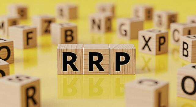 Wooden blocks spelling RRP on a yellow surface surrounded by other lettered blocks representing retail price and pricing strategy in a bright and playful setting conveying clarity and transparency photo