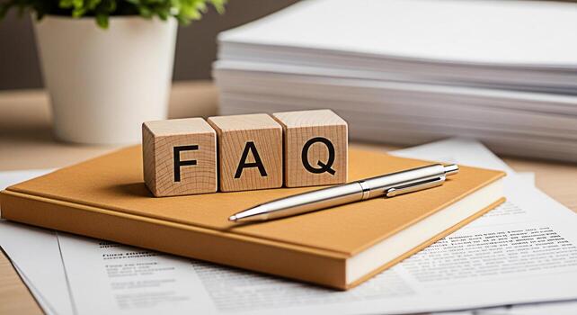 Wooden FAQ blocks resting on a tan notebook in a bright office setting symbolizing readily available information and customer support for frequently asked questions and problemsolving solutions photo