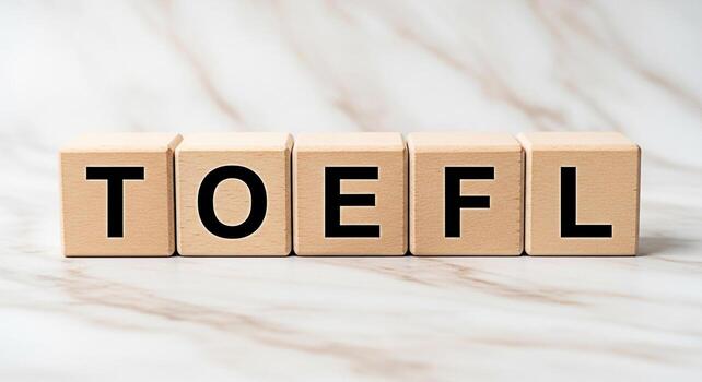 Wooden blocks spelling TOEFL on a marble surface representing the Test of English as a Foreign Language symbolizing education preparation and success in language proficiency assessment photo