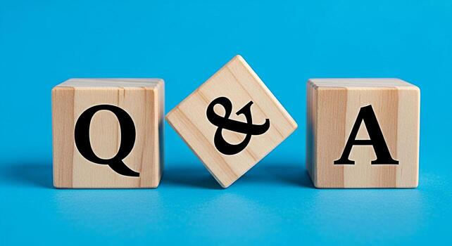 Wooden blocks displaying Q A on a bright blue background representing questions and answers knowledge sharing and interactive communication in a simple and clear visual concept photo