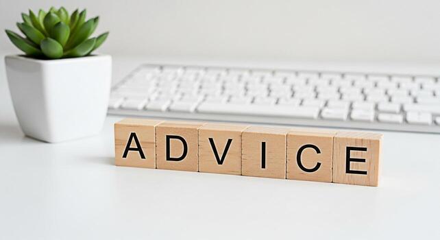 Wooden blocks spelling Advice on a clean white desk with a modern keyboard and a small succulent representing guidance and support in a professional and calming environment fostering trust and clarity photo