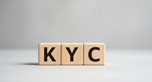 Wooden blocks spelling KYC on a gray surface representing the process of Know Your Customer in a financial and regulatory compliance context promoting trust and security in business relationships photo