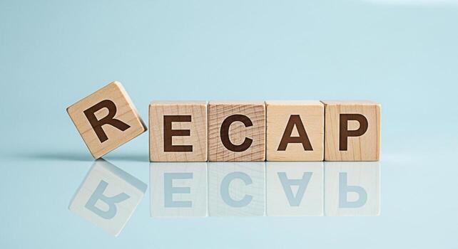 Wooden blocks spelling RECAP on a reflective surface against a light blue background symbolizing review and summary perfect for business presentations and endofyear reports with a clean and modern aes photo