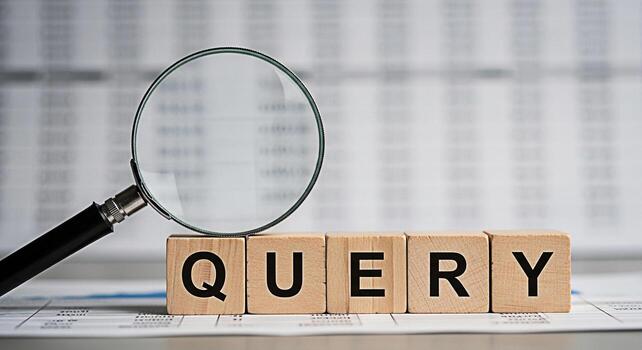 Magnifying glass examining the word Query spelled out with wooden blocks on a financial report symbolizing investigation research and data analysis in a business environment conveying a sense of scrut photo