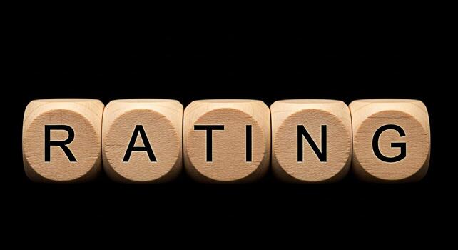 Wooden dice spelling out RATING in a dark studio setting symbolizing evaluation and assessment conveying a sense of importance and decisionmaking in business and personal contexts photo