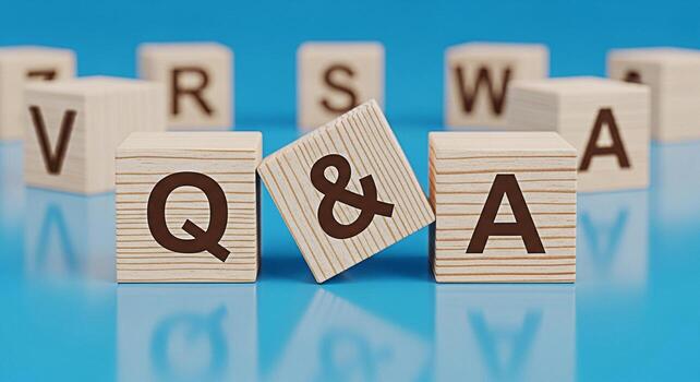 Wooden blocks displaying Q A on a blue reflective surface representing questions and answers in a learning environment creating a mood of curiosity and knowledge acquisition photo