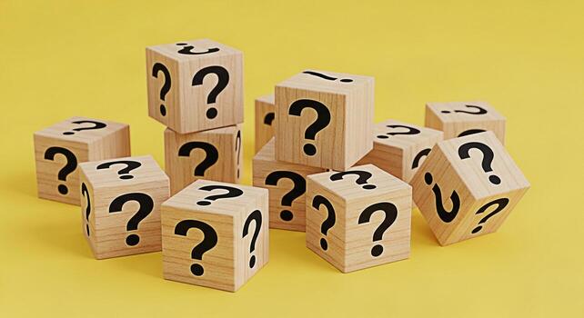 Pile of wooden blocks displaying question marks on a yellow background representing uncertainty problemsolving and the search for answers in a bright and inquisitive setting photo