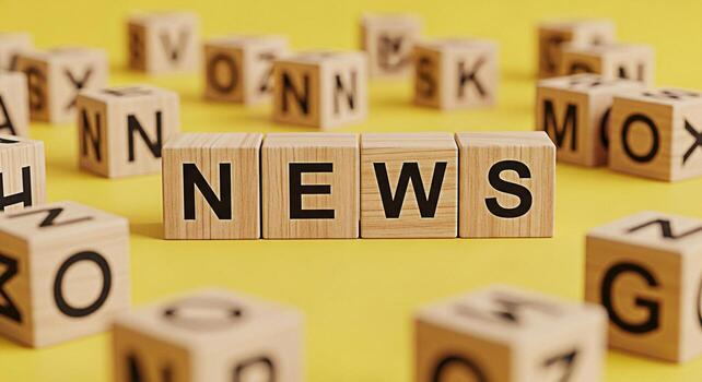 Wooden blocks spelling NEWS on a yellow surface conveying information and current events in a simple and eyecatching way ideal for media journalism and educational content symbolizing knowledge photo