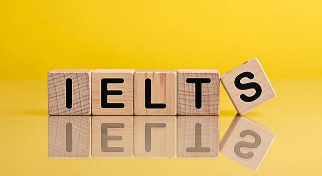 Wooden blocks spelling IELTS on a yellow reflective surface symbolizing preparation and success in the International English Language Testing System exam creating a bright and optimistic atmosphere fo photo