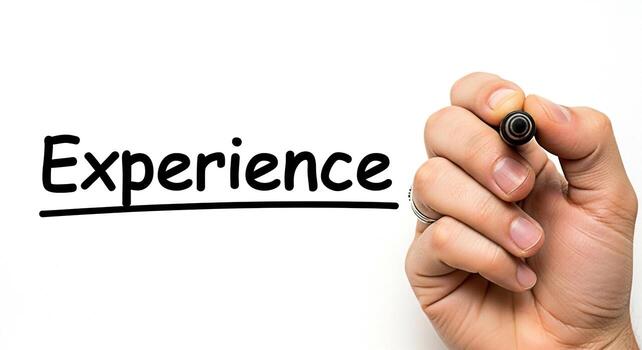 Hand writing the word Experience on a white surface with a black marker emphasizing the importance of learning and growth through practical application and skill development in a professional setting photo
